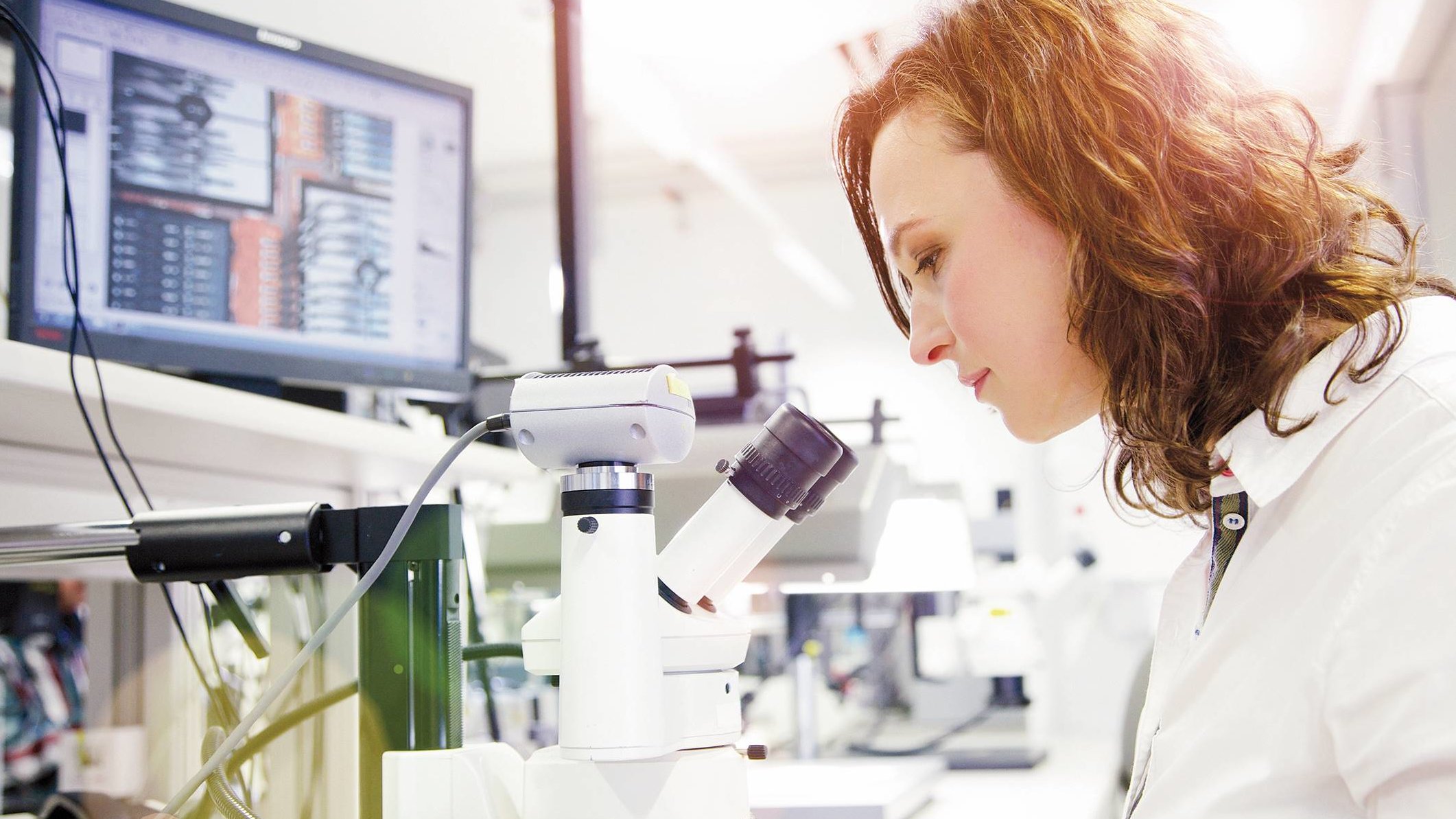 Research and Development at Infineon Technologies Austria Researcher of the R&D department examines a microchip under the microscope