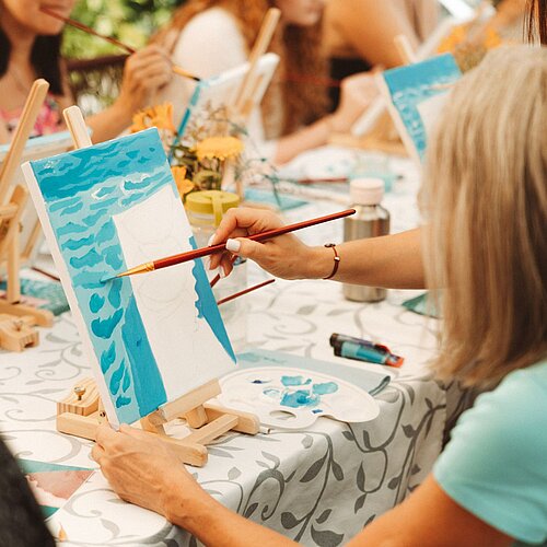 A woman painting a canvas