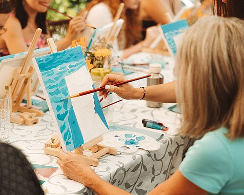 A woman painting a canvas