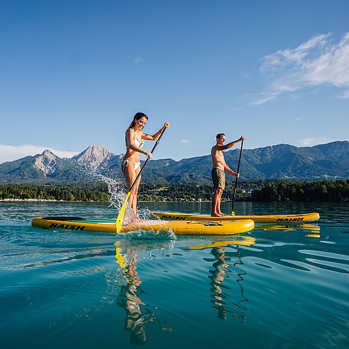 Couple doing SUPs at one at the Villach's region lakes