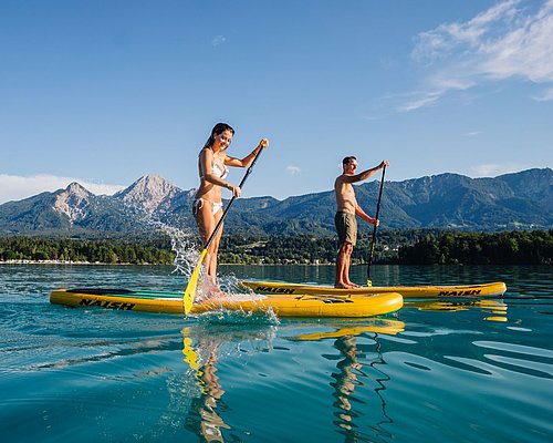 Couple doing SUPs at one at the Villach's region lakes