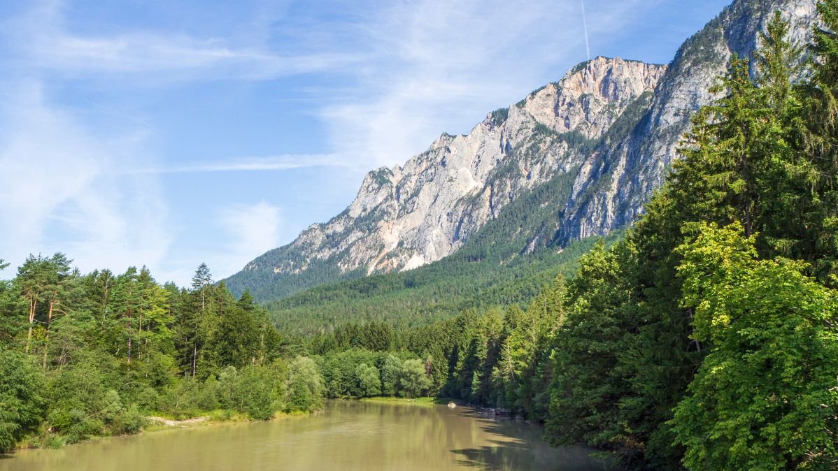 Lakes and green woods with a mountain in the background