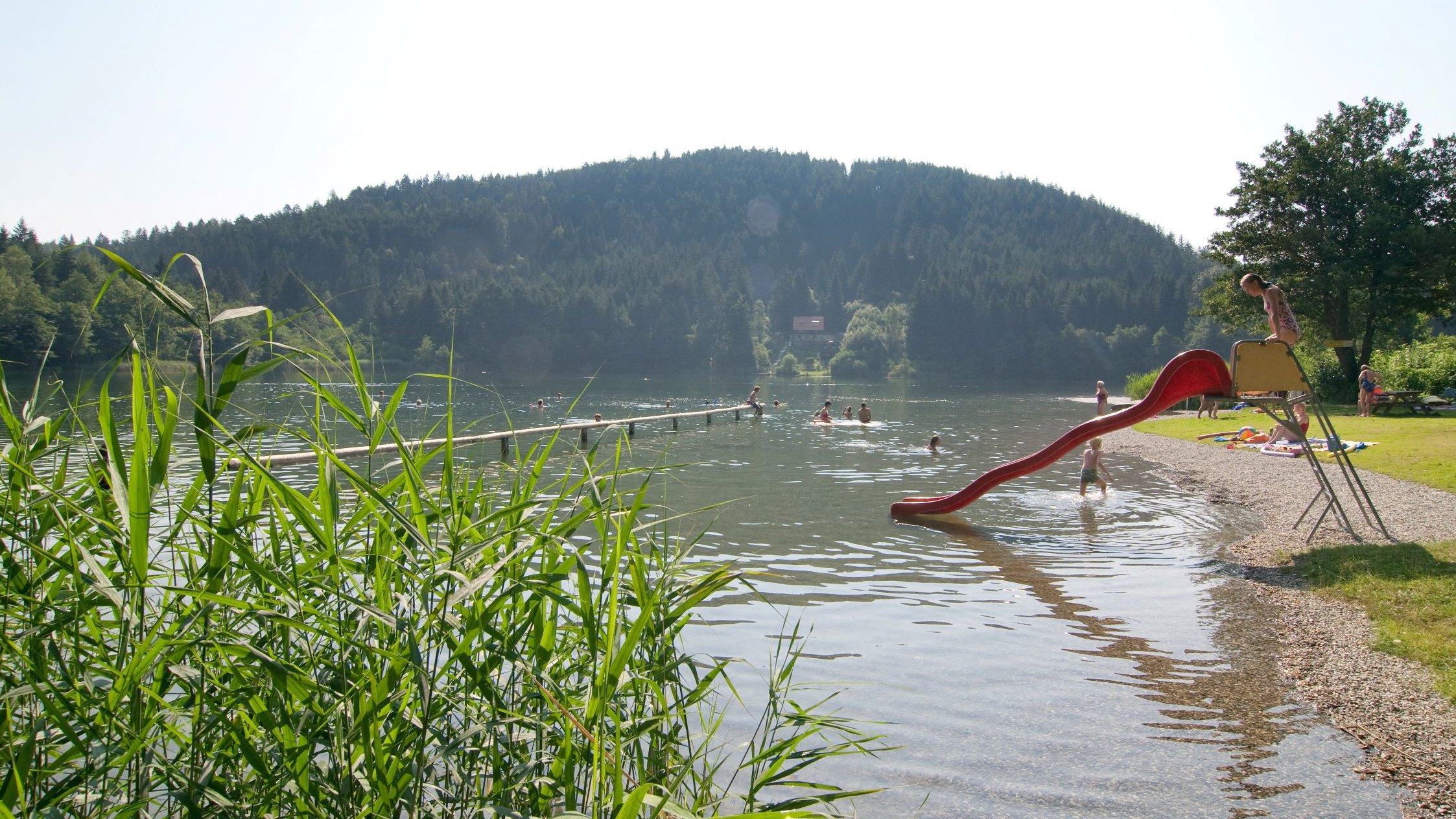 Children playing and swimming in Lake Vassacher See