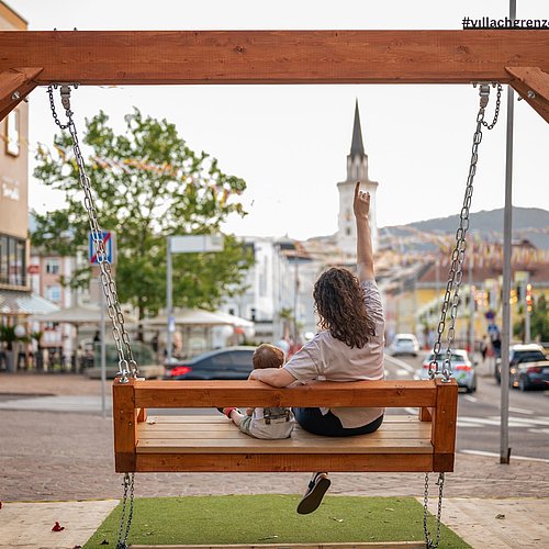 Mother and child sitting on a swing