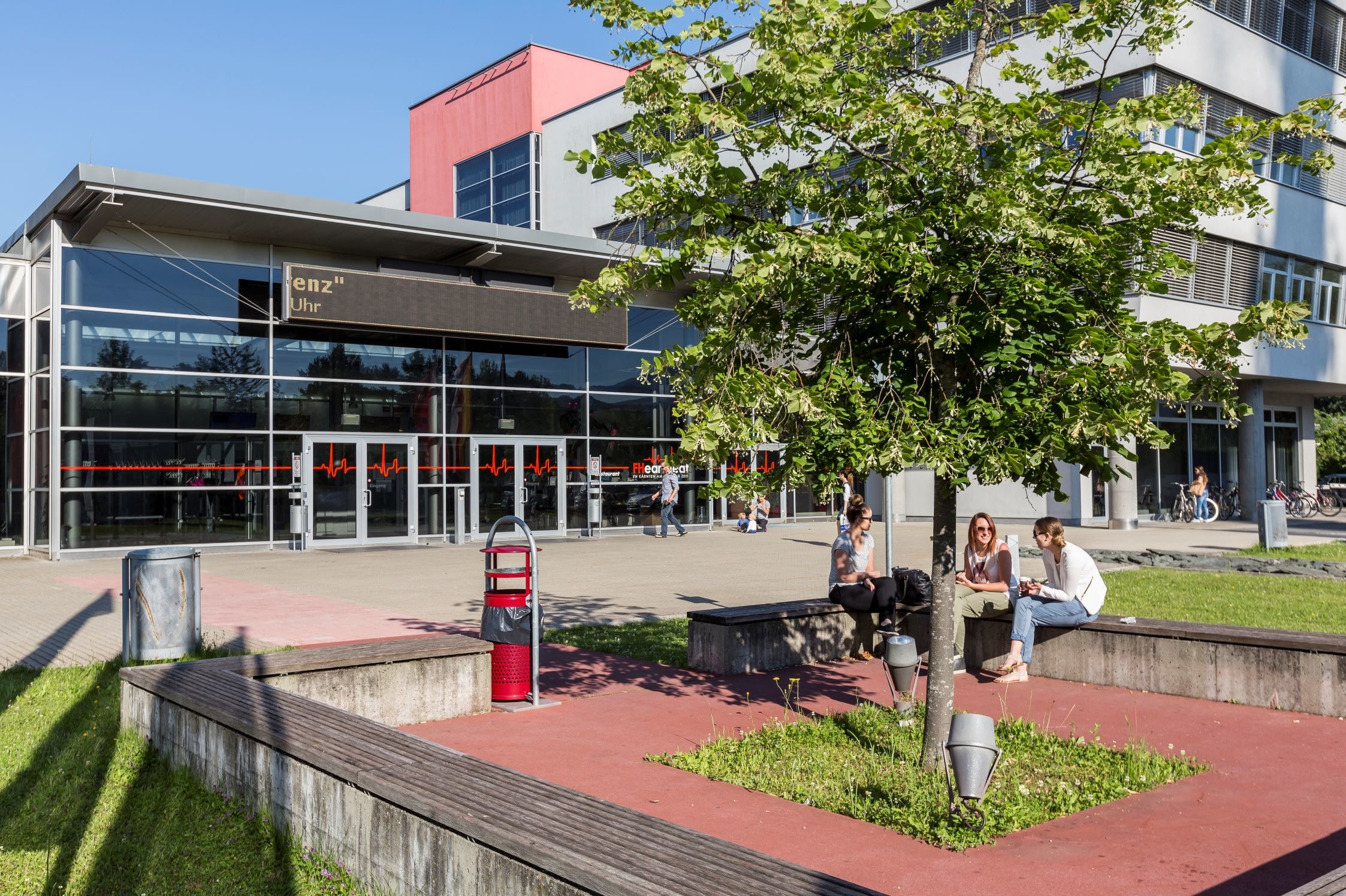 Students sitting on a bench infront of the CUAS building