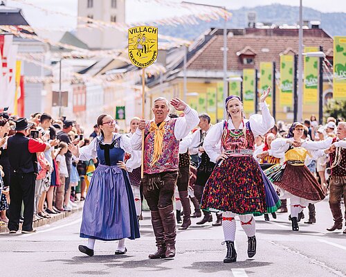The big Trachten Parade of Villacher Kirchtag People in traditional costume wave to the viewers