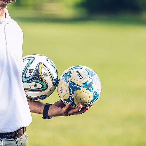 Soccer Trainer holding the balls