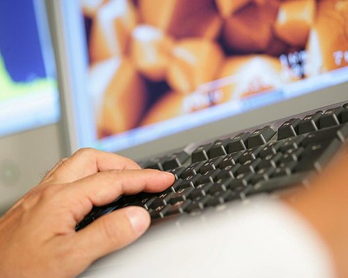 Someone writing on a laptop's keyboard