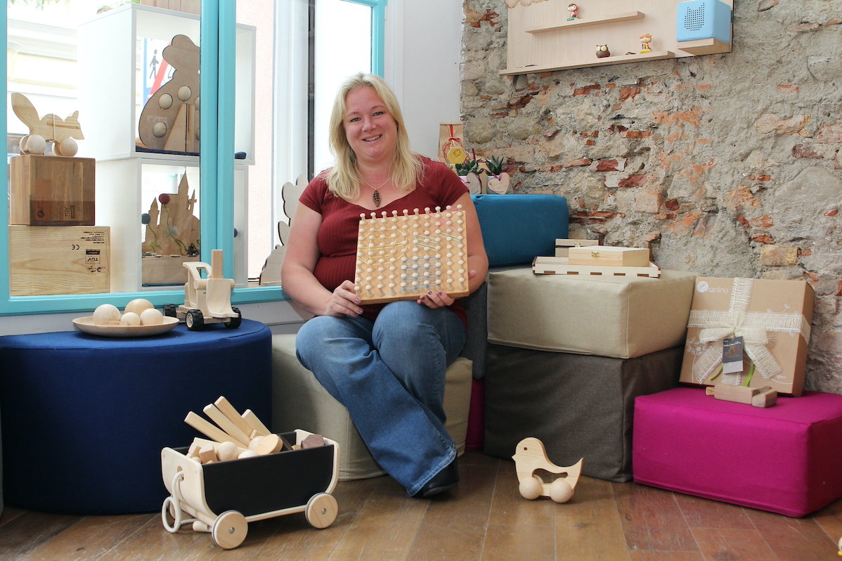 Woman presents wooden toys