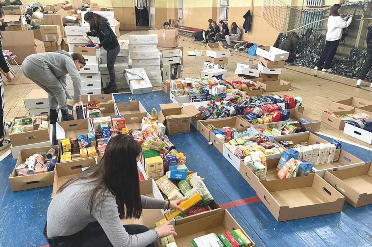 Freiwillige sortieren Spenden in einer Halle