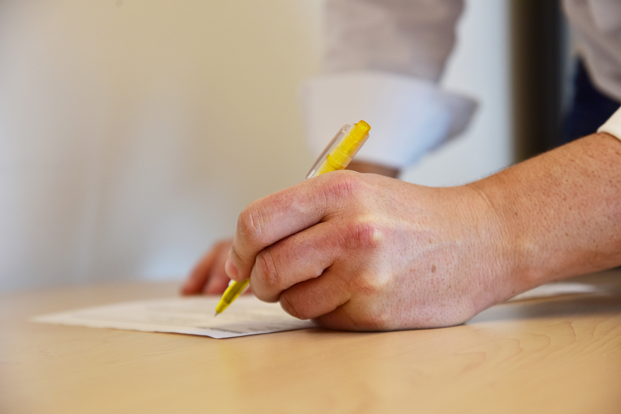 A man signs a work contract