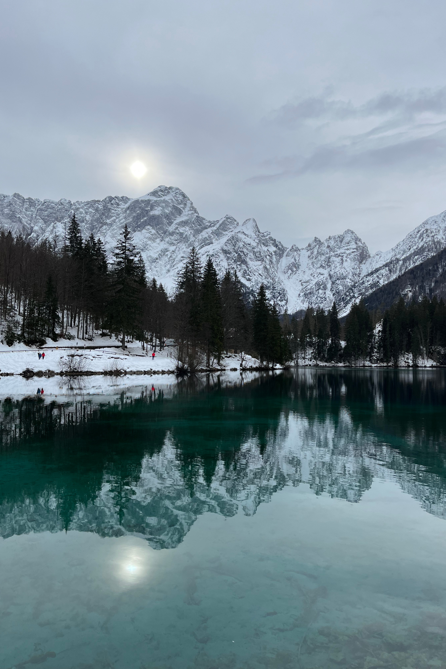 The dreamlike Laghi di Fusine in the glittering winter sun