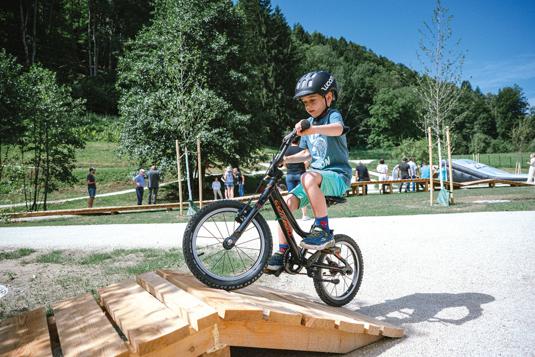 Child rides bicycle over a ramp