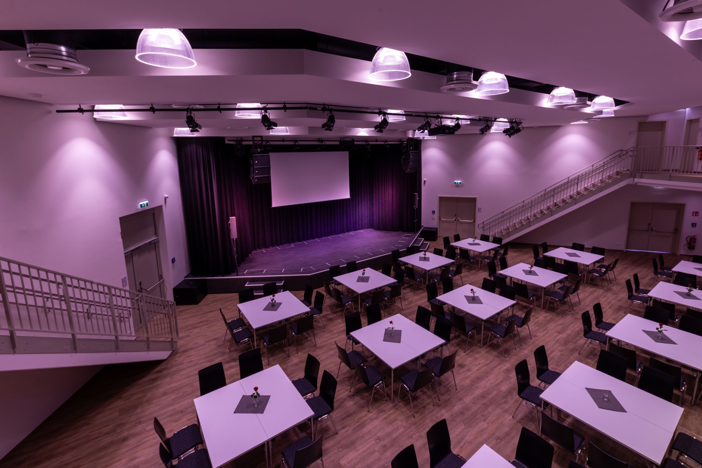 Event hall with arranged tables and a stage